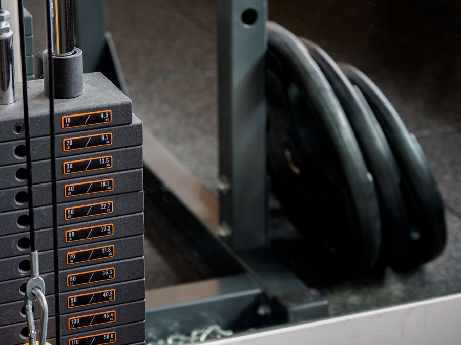 A man holding a dumbbell in a gym